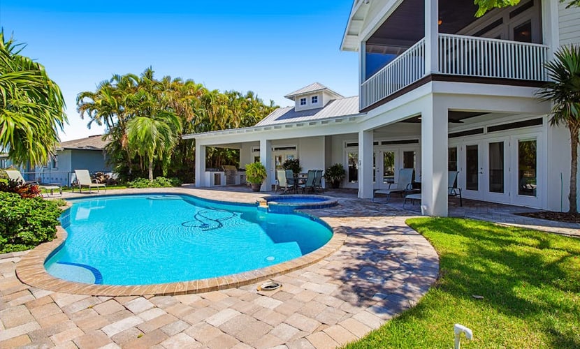 Waterfront home with heated pool + spa, patio, grill, & free WiFi - dog-friendly