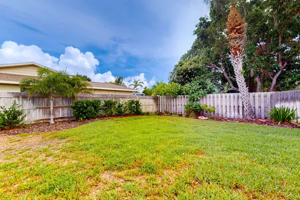 Snowbird-friendly home near beaches with enclosed yard, grill, screened patio