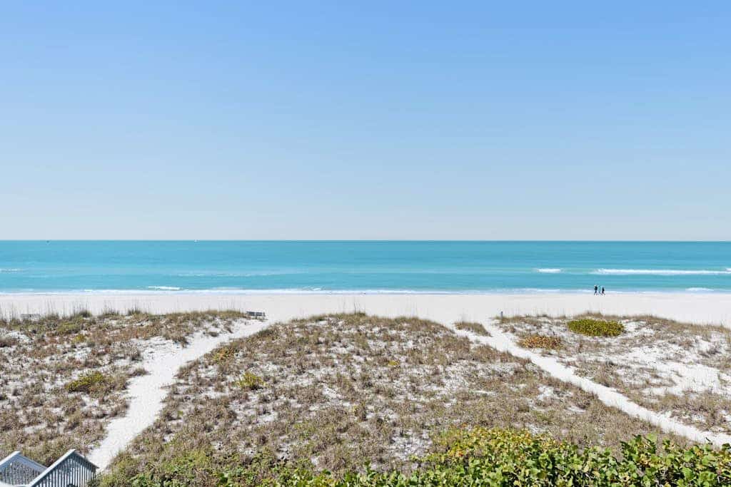 Beachfront condo with WiFi, two decks, Gulf views & pool - walk to the trolley