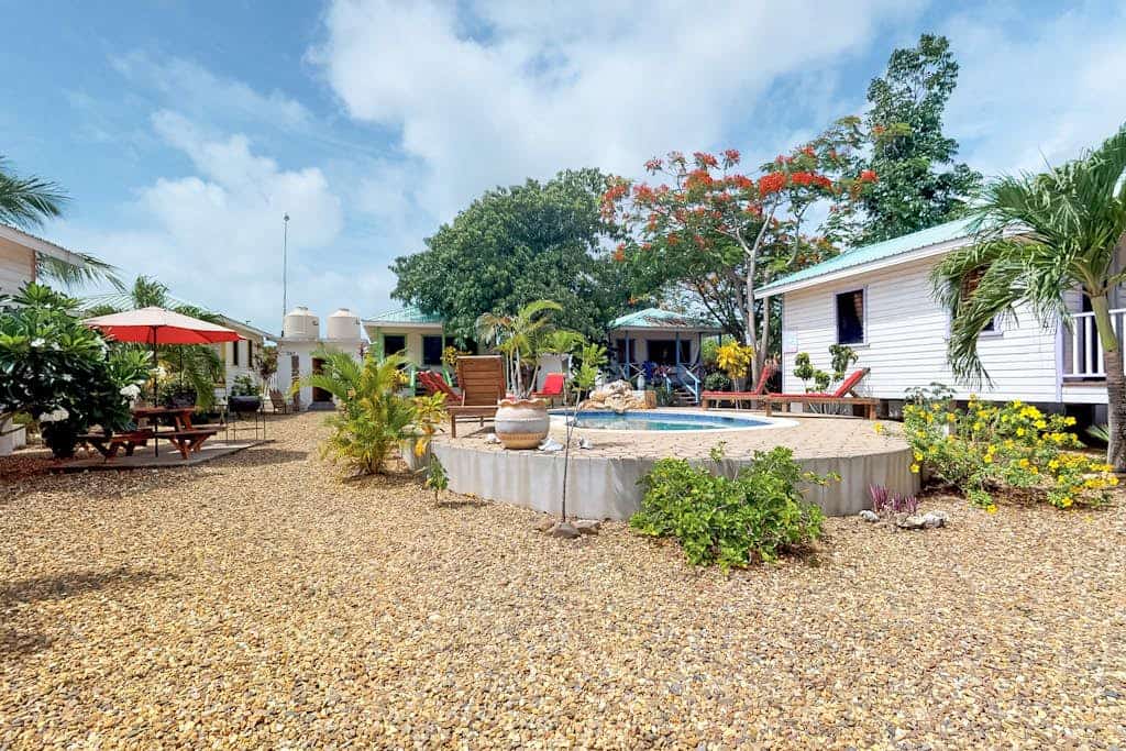 Cabana with a porch, hammock, & view of the pool & grilling area