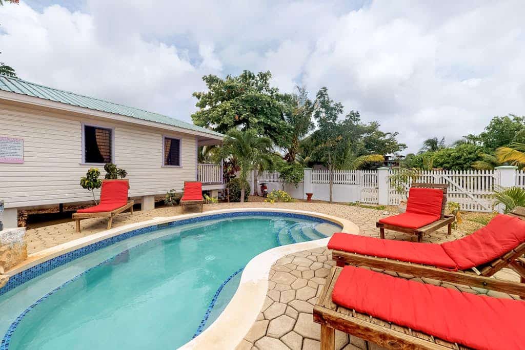 Wood cabana with a porch, pool view, WiFi, and a shared common area with grills