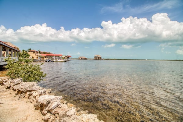 Waterfront resort villa with water views, balcony, full kitchen, & washer/dryer