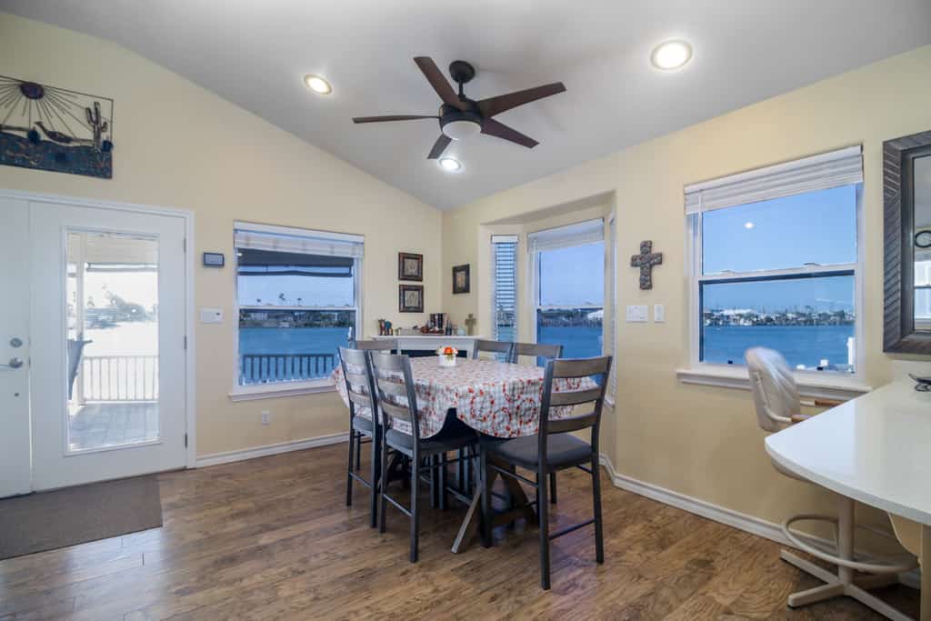 Welcome to Coastal Breeze, a waterfront cottage in the gated Long Island Village resort near Port Isabel. Sip coffee on the covered deck where dolphins are a familiar sight and the sun sets over the water. Inside, find an open living and dining area, a full kitchen, and two comfortable bedrooms. Dive into the resort pools, play the 18-hole golf course, or cross the causeway to South Padre Island beaches in minutes. Your easygoing Gulf Coast escape starts here.