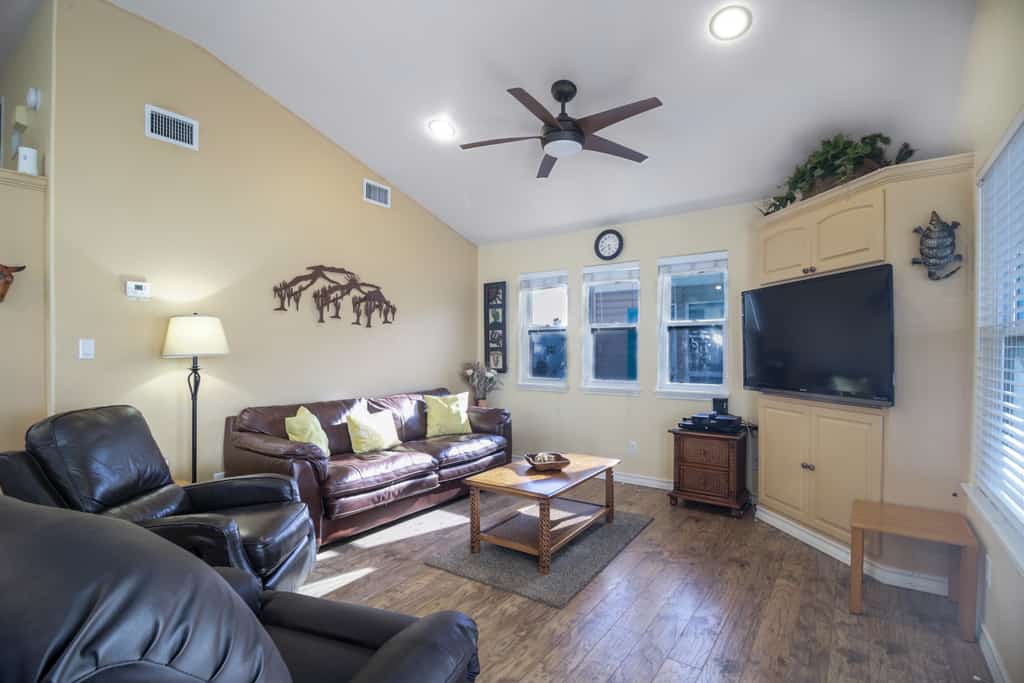 Welcome to Coastal Breeze, a waterfront cottage in the gated Long Island Village resort near Port Isabel. Sip coffee on the covered deck where dolphins are a familiar sight and the sun sets over the water. Inside, find an open living and dining area, a full kitchen, and two comfortable bedrooms. Dive into the resort pools, play the 18-hole golf course, or cross the causeway to South Padre Island beaches in minutes. Your easygoing Gulf Coast escape starts here.
