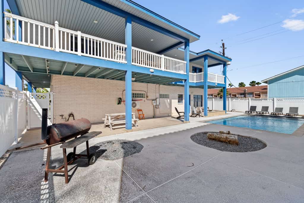 Welcome to Paradise on Padre, a bright two-story island home on the beach side of South Padre with a private fenced pool, a fountain-fed tanning shelf, and the sand a short walk away. Upstairs, an open living, kitchen, and dining space flows to a wrap-around balcony with pool and water views, while a downstairs game room brings foosball, billiards, and a kitchenette. With room for up to 16 guests across three bedrooms, it is made for big families to gather, play, and unwind by the water.