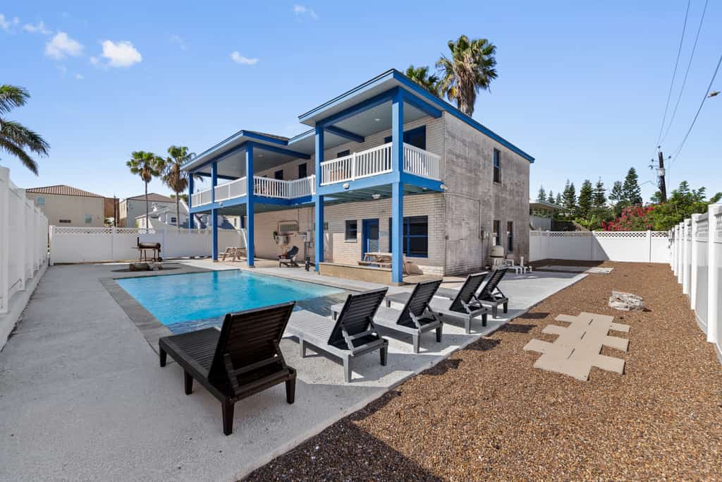 Welcome to Paradise on Padre, a bright two-story island home on the beach side of South Padre with a private fenced pool, a fountain-fed tanning shelf, and the sand a short walk away. Upstairs, an open living, kitchen, and dining space flows to a wrap-around balcony with pool and water views, while a downstairs game room brings foosball, billiards, and a kitchenette. With room for up to 16 guests across three bedrooms, it is made for big families to gather, play, and unwind by the water.