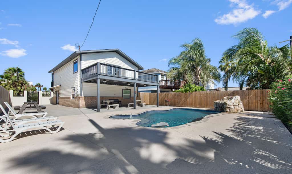 Welcome to Seascape Villa, a bright two-story island home built for big groups and easy gathering. Splash in the private pool with its waterfall and built-in benches, fire up the grill, then spread out across five bedrooms that sleep sixteen. Cook together at the kitchen island, challenge the crew in the upstairs game room, and catch the bay breeze from the balcony. Just minutes from South Padre beaches, dining, and water parks, this is your home base for an unforgettable island escape.