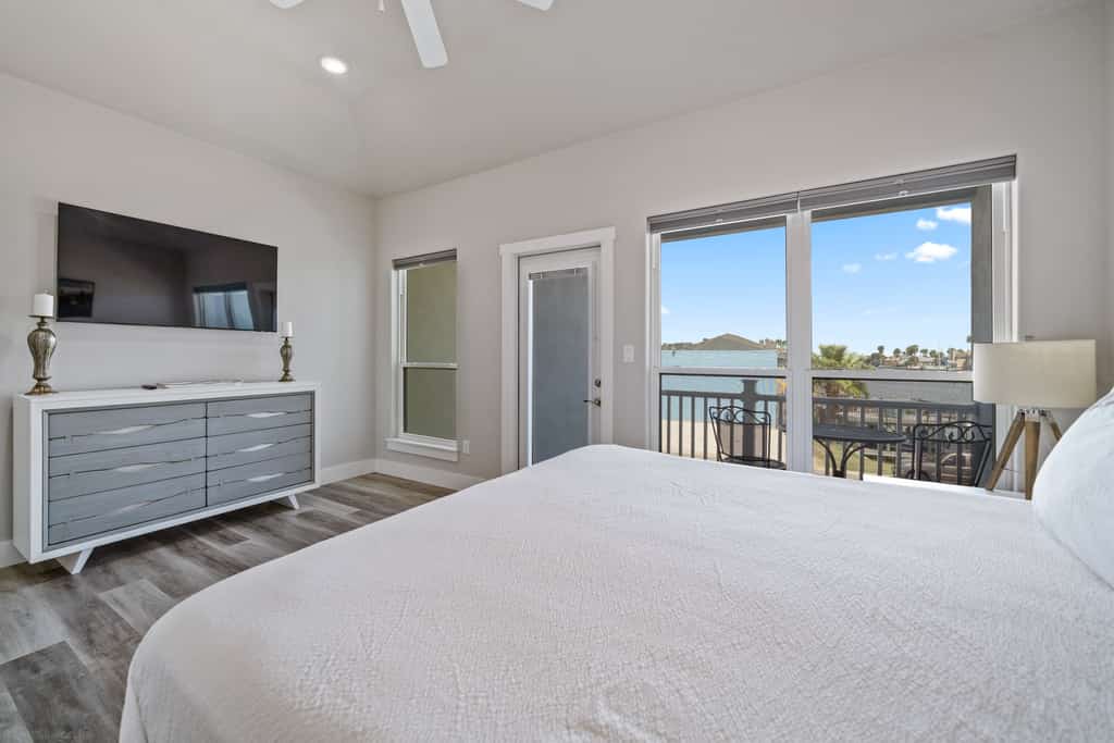 Welcome to Endless Sunlight, a bright two-story island retreat in the heart of Padre Isles. Spend sunny afternoons cooling off in your private heated pool, then unwind on the turf patio as the sky lights up at sunset. Inside, an open living and kitchen make gathering easy, while three upstairs bedrooms each feature a smart TV. The primary suite opens to its own balcony with water views. You are just minutes from Whitecap Beach, Padre Balli Park, and Laguna Madre fishing.