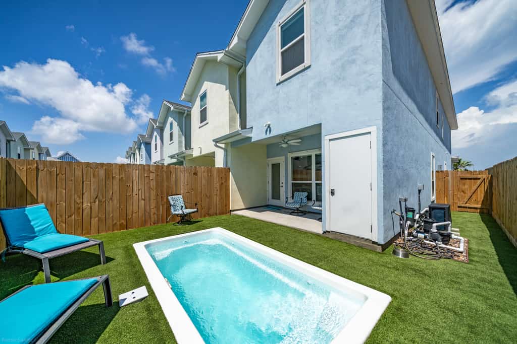 Welcome to Endless Sunlight, a bright two-story island retreat in the heart of Padre Isles. Spend sunny afternoons cooling off in your private heated pool, then unwind on the turf patio as the sky lights up at sunset. Inside, an open living and kitchen make gathering easy, while three upstairs bedrooms each feature a smart TV. The primary suite opens to its own balcony with water views. You are just minutes from Whitecap Beach, Padre Balli Park, and Laguna Madre fishing.