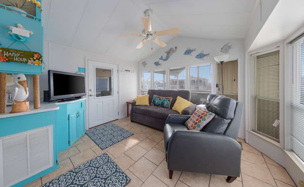 Welcome to Little Breeze, a bright single-level waterfront cottage on a quiet canal in the gated Long Island Village resort near Port Isabel. Sip coffee on the covered deck, take in water views from nearly every window, and settle into a cheerful coastal retreat with a queen bedroom and a living room sleeper sofa. Dive into the resort pools, play the par-3 golf course, or cross the causeway to South Padre Island beaches in minutes. Your easygoing Gulf Coast getaway starts here.