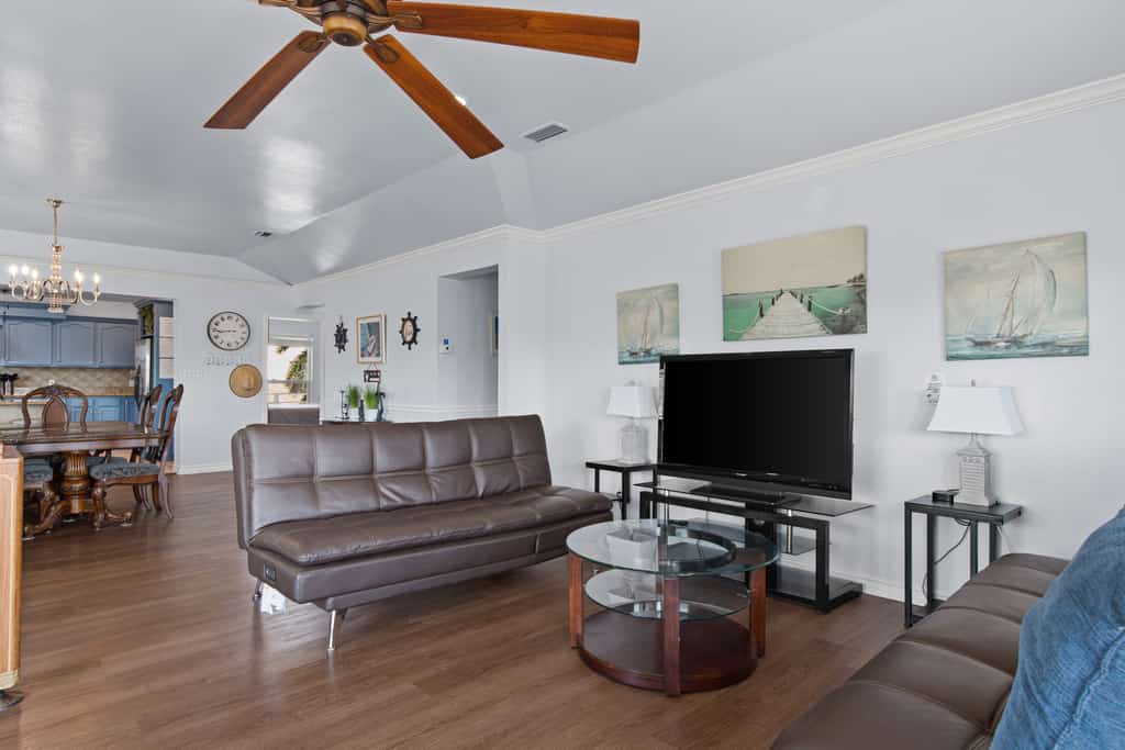 Welcome to 203 Amelia Beach House, a spacious five-bedroom island retreat built for big groups and great times on South Padre Island. Spread out across two living areas and two kitchens, then challenge the crew in the game room with a pool table, ping pong, air hockey, and arcade games. Unwind on the breezy covered decks overlooking the water, with room for up to 16 guests. It is the perfect home base for sun, fishing, and family fun on the Texas Gulf Coast.