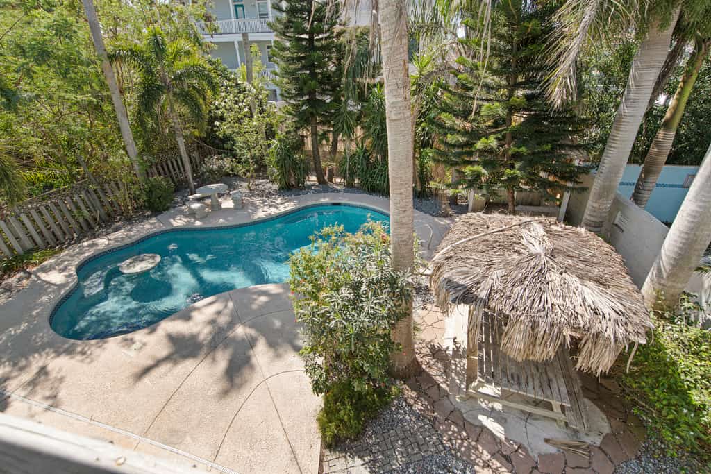 Welcome to Oleander Oasis, a bright two-story island home built for big groups on South Padre Island. Splash in your private pool, relax under the shaded palapa, and gather upstairs in a soaring open living space with a shuffleboard for friendly competition. Five bedrooms and three baths sleep 16, including two king suites and a fun bunk room for the kids. You are a short walk from the Gulf beach and minutes from Isla Blanca Park. Your island home base is ready.