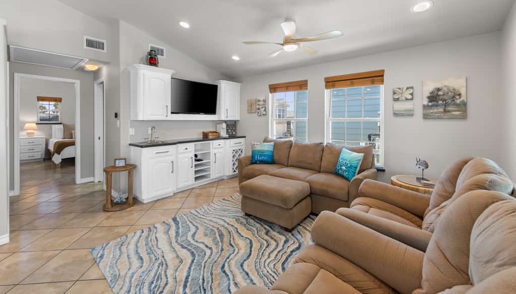 Welcome to 289 Sundial Circle, a single-level waterfront home on the channel in the gated Long Island Village resort near Port Isabel. Sip coffee on the covered deck as the water glides by, then gather in the open living, kitchen, and dining space. A king primary suite and a queen guest room rest your group in comfort. Dive into the resort pools, play the 18-hole golf course, or cross the causeway to South Padre Island beaches in minutes. Your easygoing Gulf Coast escape starts here.