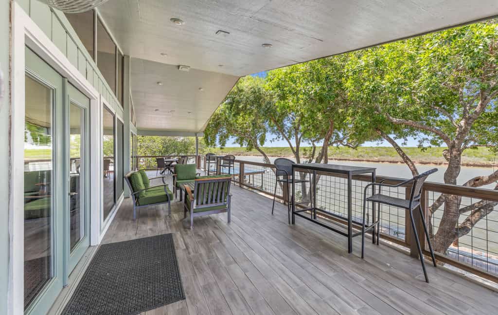 Welcome to the Upper Level of Casa Arroyo Sporting Lodge, the prime spot on the water in Arroyo City. Five bedrooms and four baths sleep up to 14, with an elevator for easy access and a wide covered balcony overlooking the arroyo and wildlife refuge. Watch boats and barges drift by, cast from the lighted pier, gather in the open great room and bar, and cook in the full kitchen. You are minutes from world-class bay fishing and the Laguna Atascosa refuge.