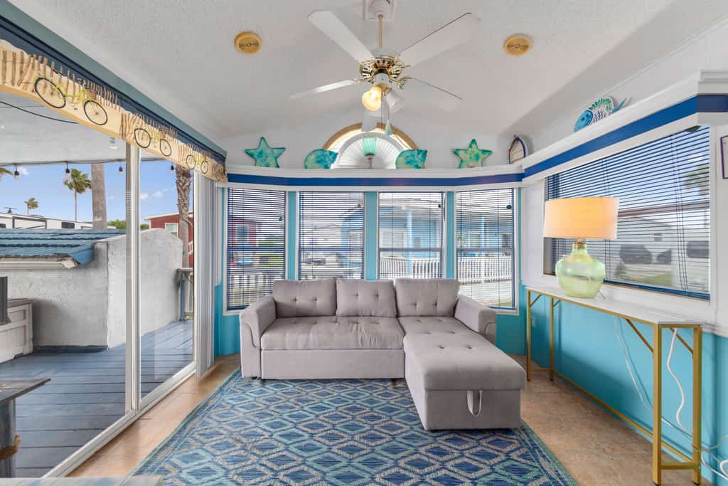 Welcome to Blue Paradise, a bright and breezy one-bedroom cottage tucked inside the gated Long Island Village resort in Port Isabel. Sink into the sunroom-style living room wrapped in windows, cook in the cheerful coastal kitchen, and unwind on your covered deck. Your stay unlocks the resort's pools, hot tubs, golf, tennis, and more, with South Padre Island's beaches just ten minutes across the causeway. Sleeps four, and your dog is welcome too.