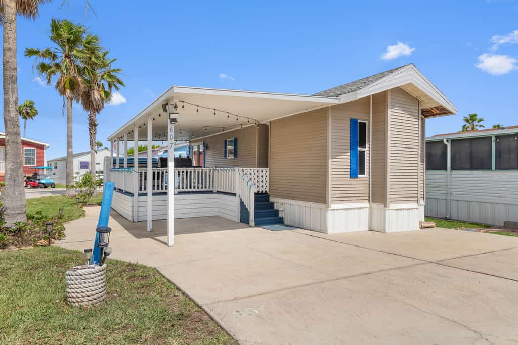 Welcome to Blue Paradise, a bright and breezy one-bedroom cottage tucked inside the gated Long Island Village resort in Port Isabel. Sink into the sunroom-style living room wrapped in windows, cook in the cheerful coastal kitchen, and unwind on your covered deck. Your stay unlocks the resort's pools, hot tubs, golf, tennis, and more, with South Padre Island's beaches just ten minutes across the causeway. Sleeps four, and your dog is welcome too.