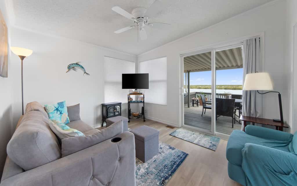 Welcome to Little Launch, a bright waterfront cottage tucked into the gated Long Island Village resort near Port Isabel. Watch the water from your covered deck, catch SpaceX launches lighting up the sky across the bay, and cook easy meals in the full kitchen before heading to the resort pools, golf, and tennis. A queen bedroom and living-room sofa bed sleep four, and South Padre Island beaches are a short drive over the causeway. Coastal calm with a front-row view of the future.