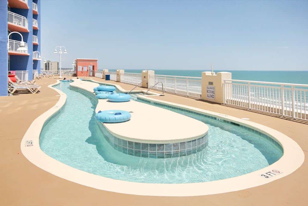Ocean View condo with a balcony, heated pool, hot tub, W/D, gym, & beach access
