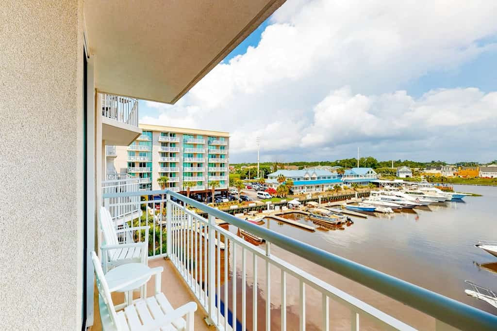 Third-floor condo with pool, hot tub, marina view & private W/D