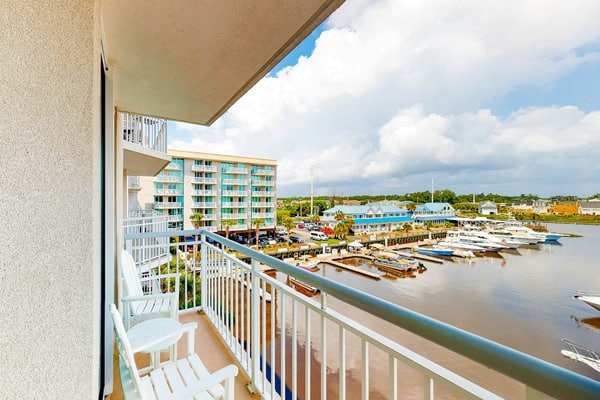 Third-floor condo with pool, hot tub, marina view & private W/D