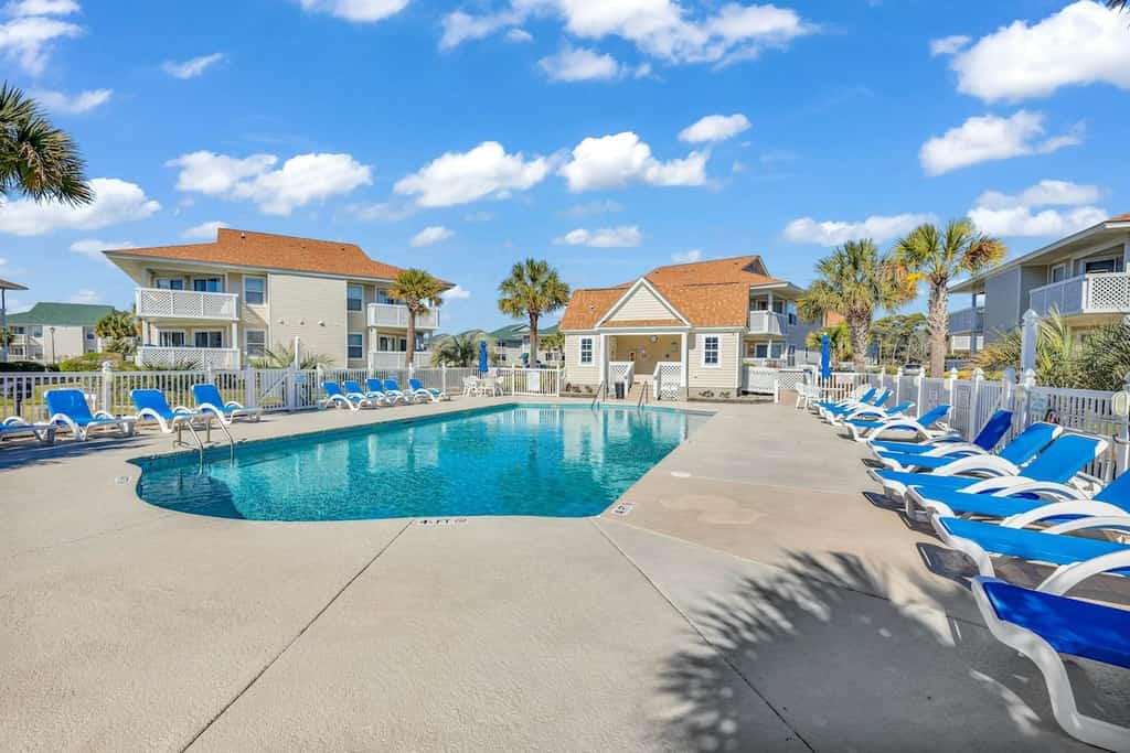 Pool view condo with balcony, pool, hot tub & steps to beach