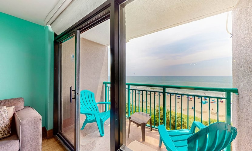 Beachfront condo with ocean-view balcony, A/C, and Smart TVs
