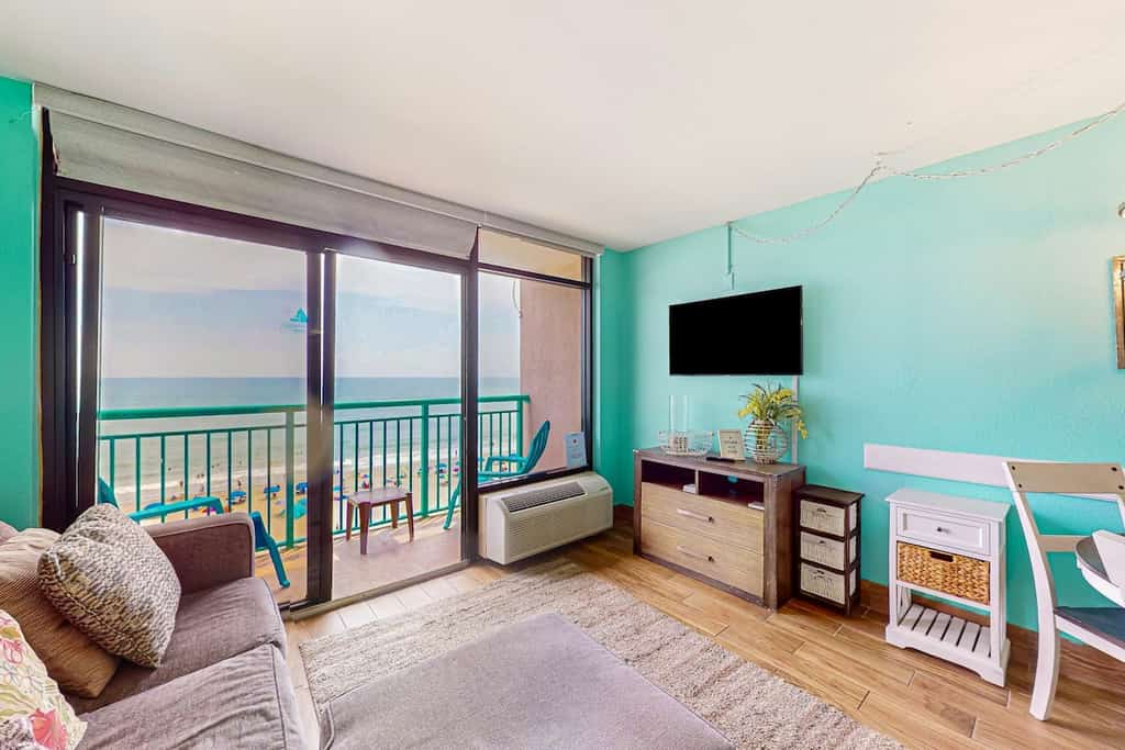 Beachfront condo with ocean-view balcony, A/C, and Smart TVs