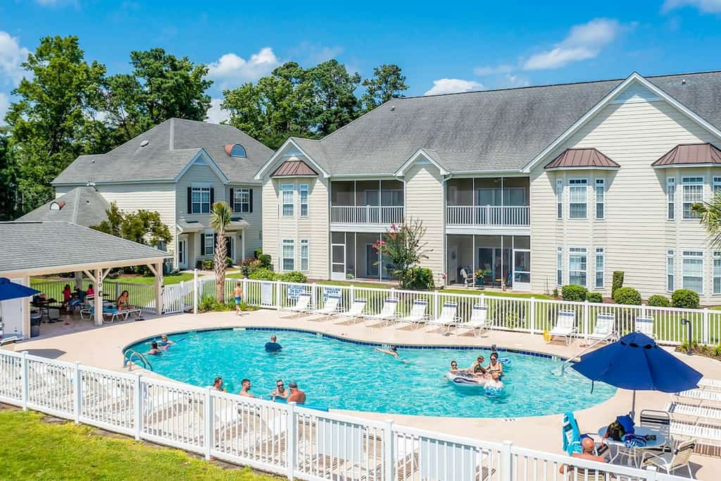 Lake-view ground-floor condo with screened patio, W/D, & pool