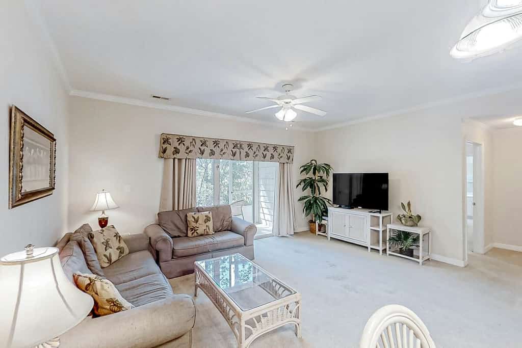 Lake-view ground-floor condo with screened patio, W/D, & pool