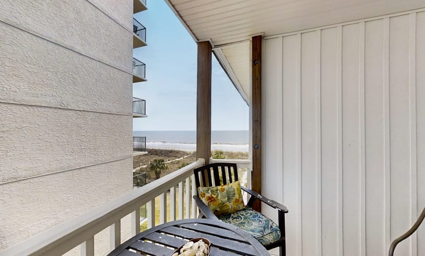 Third-floor beachfront retreat with furnished balcony, pool, washer/dryer