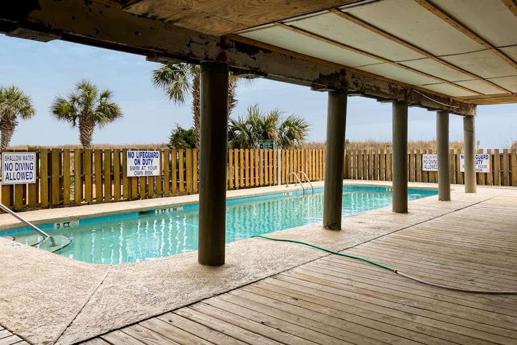 Third-floor beachfront retreat with furnished balcony, pool, washer/dryer