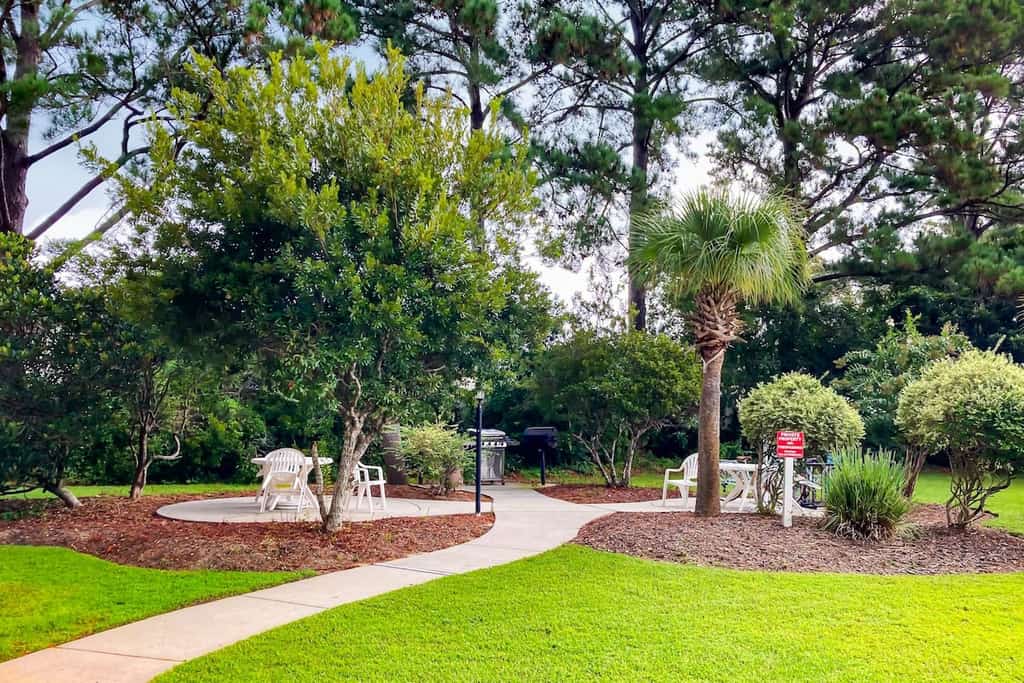 Sunny condo with pool access, coastal theme, balcony, W/D, and central AC