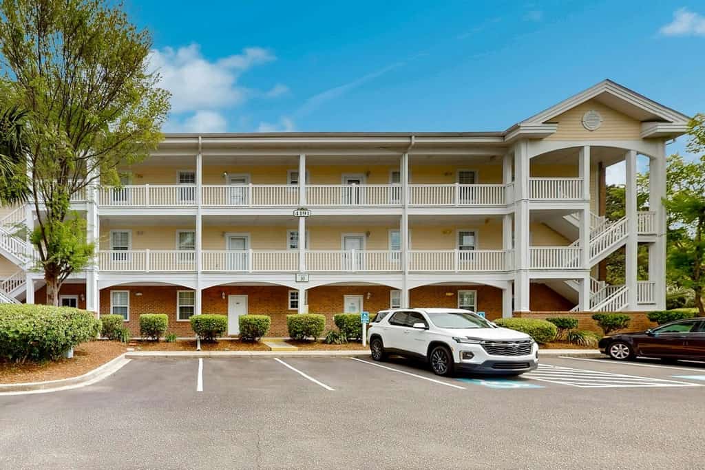 Sunny condo with pool access, coastal theme, balcony, W/D, and central AC