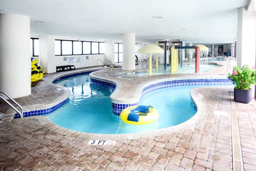 Ocean-view condo with beach access, pools, splash pad, lazy river, AC, & balcony