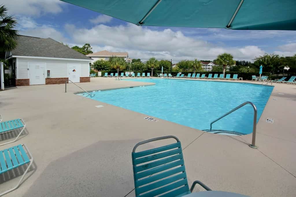 Lovely condo with turquoise pool, balcony, open layout, central AC, & W/D