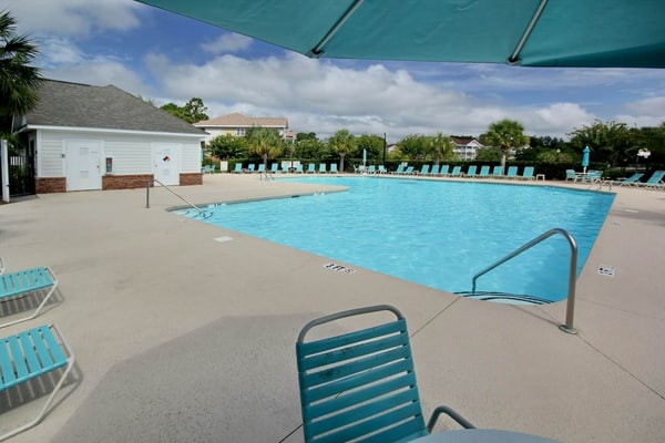 Lovely condo with turquoise pool, balcony, open layout, central AC, & W/D