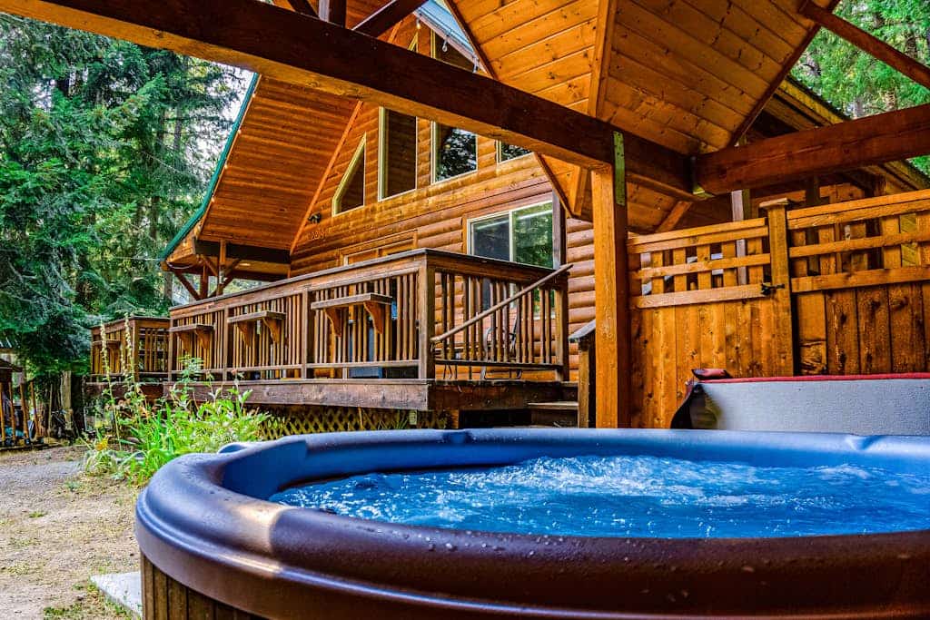 Elegant, secluded home with a wood deck, gas grill, & private hot tub