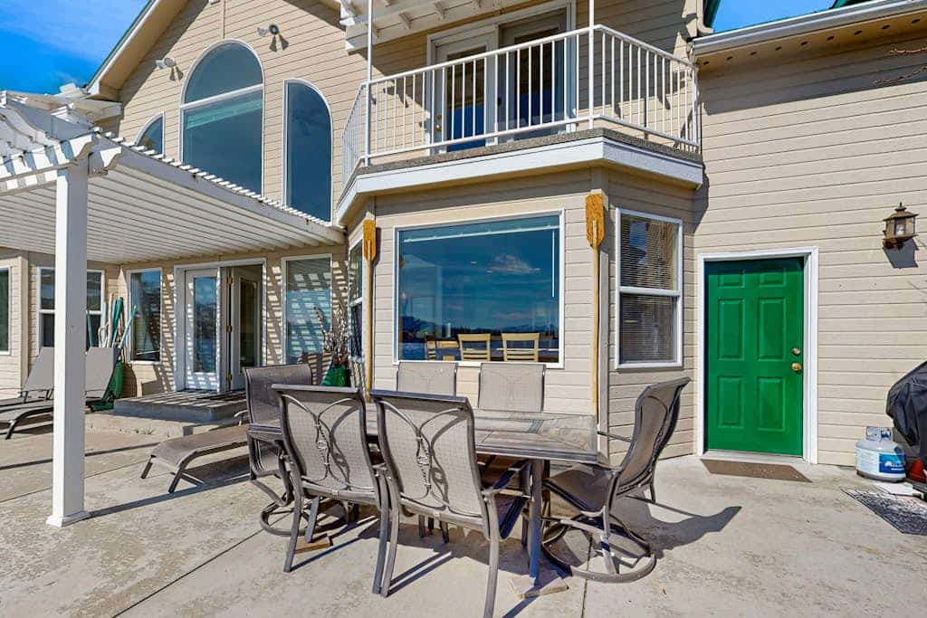 Sunny, lakefront home with huge patio, floating dock & 2 buoys