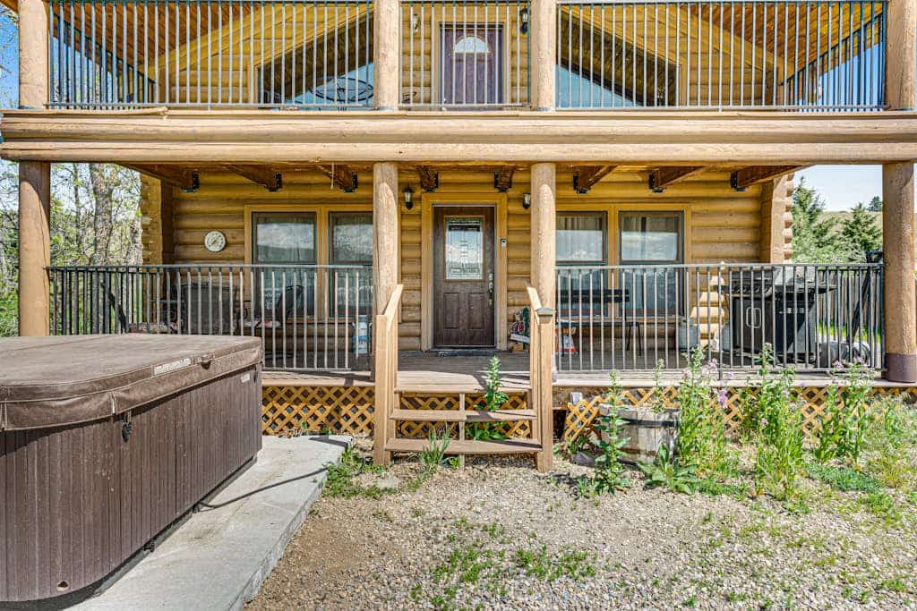 Escape to Waterwheel Retreat, a charming custom log home nestled just one mile from Sturgis. This picturesque getaway offers the perfect blend of rustic comfort and modern convenience, featuring a private patio hot tub and two cozy fireplaces. With three spacious bedrooms and a loft, it is an ideal home base for exploring the Black Hills, including Mount Rushmore and Deadwood. Enjoy easy access to I-90 while relaxing in a quiet, serene setting that is perfect for families and travelers seeking a peaceful mountain retreat.