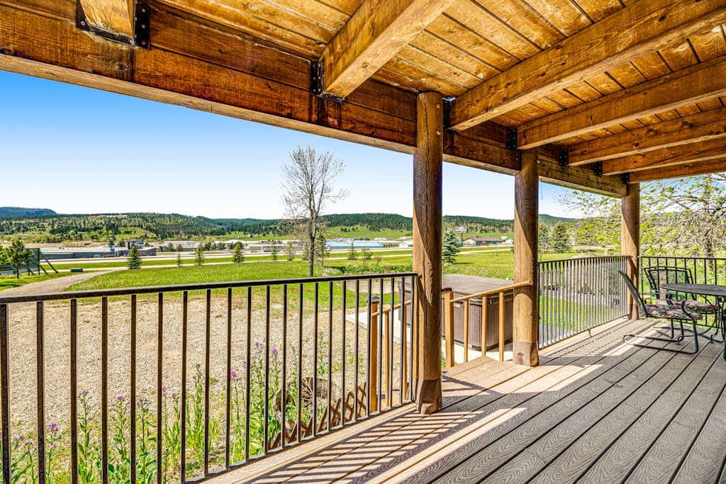 Escape to Waterwheel Retreat, a charming custom log home nestled just one mile from Sturgis. This picturesque getaway offers the perfect blend of rustic comfort and modern convenience, featuring a private patio hot tub and two cozy fireplaces. With three spacious bedrooms and a loft, it is an ideal home base for exploring the Black Hills, including Mount Rushmore and Deadwood. Enjoy easy access to I-90 while relaxing in a quiet, serene setting that is perfect for families and travelers seeking a peaceful mountain retreat.