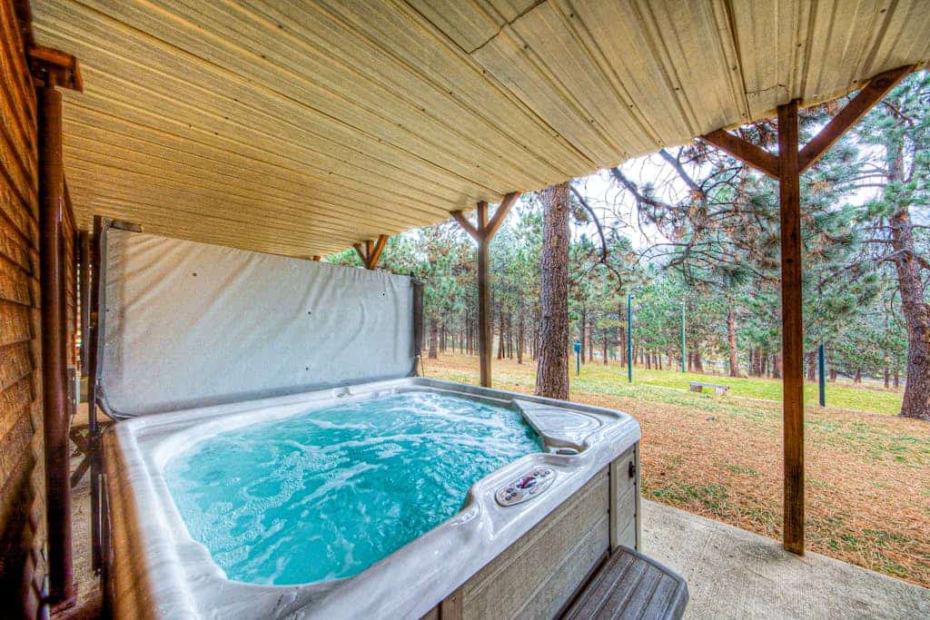 Come experience Crooked Canyon Lodge, a lovely four bedroom retreat tucked away on twenty private acres near Rapid City. This home is perfect for families and pets, featuring wonderful amenities like a hot tub, sauna, and sand volleyball court. You will love the convenience of two full kitchens and spacious living areas, all while staying just minutes from landmarks like Mount Rushmore and Sturgis. It is the perfect spot to enjoy peaceful mountain surroundings while staying close to all the fun in South Dakota.