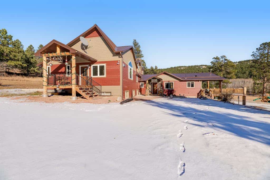 Escape to Whitegate Lodge, a stunning 6-bedroom retreat nestled in the Black Hills near Nemo. Perfect for large groups, this fully remodeled home features two kitchens, private loft spaces, and a relaxing hot tub. Enjoy valley views from the expansive deck, complete with a gas firepit and grill. Ideally located for outdoor adventures, you are just minutes from hiking trails and Dalton Lake. Experience the perfect blend of secluded mountain charm and modern comfort near Rapid City and Sturgis.