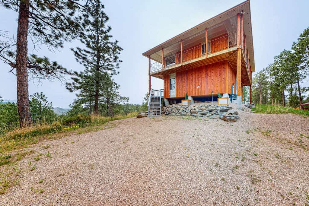Experience the perfect blend of rustic charm and modern luxury at this custom 3 bedroom cabin in the Black Hills. Located just a mile from Hill City, this secluded retreat offers breathtaking 360 degree mountain views from a private wraparound deck. Enjoy a spacious chef kitchen, plush living areas, and a primary suite with a deep soaking tub. Perfectly positioned as your central base for Mount Rushmore, Crazy Horse, and the 1880 Train, it is an ideal escape for families seeking comfort and adventure.