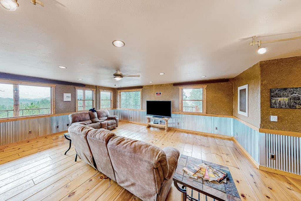 Experience the perfect blend of rustic charm and modern luxury at this custom 3 bedroom cabin in the Black Hills. Located just a mile from Hill City, this secluded retreat offers breathtaking 360 degree mountain views from a private wraparound deck. Enjoy a spacious chef kitchen, plush living areas, and a primary suite with a deep soaking tub. Perfectly positioned as your central base for Mount Rushmore, Crazy Horse, and the 1880 Train, it is an ideal escape for families seeking comfort and adventure.