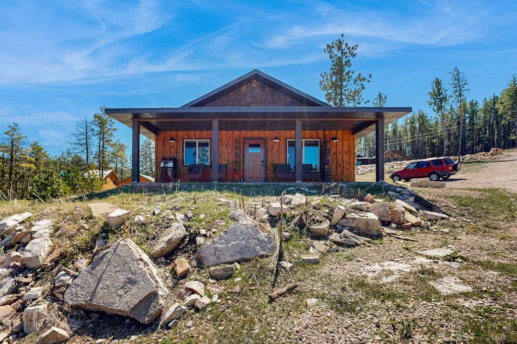Escape to Rost Place Round-Up, a cozy cabin in Sturgis offering stunning mountain views and convenient single-level living. Located right across from Boulder Canyon Golf Course, this retreat features a relaxing fireplace, a fully equipped kitchen, and a furnished porch perfect for morning coffee. Whether you are exploring nearby hiking trails, visiting the Sturgis Motorcycle Museum, or taking a trip to Mount Rushmore, our cabin provides the perfect peaceful base for your Black Hills adventure.