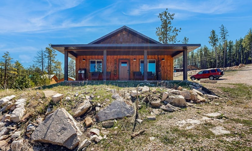 Escape to Rost Place Round-Up, a cozy cabin in Sturgis offering stunning mountain views and convenient single-level living. Located right across from Boulder Canyon Golf Course, this retreat features a relaxing fireplace, a fully equipped kitchen, and a furnished porch perfect for morning coffee. Whether you are exploring nearby hiking trails, visiting the Sturgis Motorcycle Museum, or taking a trip to Mount Rushmore, our cabin provides the perfect peaceful base for your Black Hills adventure.