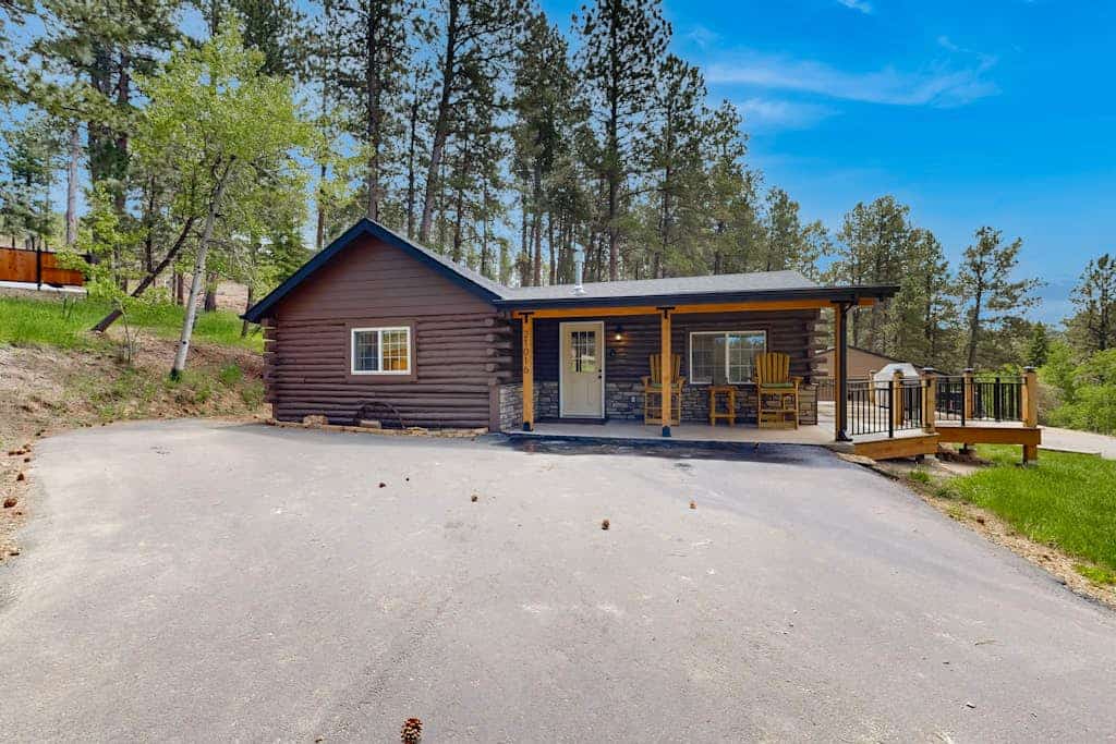 Escape to Two Bit Cabin, a newly remodeled retreat nestled in the heart of the Black Hills near Deadwood, South Dakota. This peaceful 2-bedroom cabin offers the perfect blend of modern comfort and rustic charm, featuring a private hot tub, a cozy gas fireplace, and a fully equipped kitchen. Relax on your spacious deck while taking in mountain views and watching wildlife at the adjacent catch and release fishing pond. Ideally located just 4 miles from Deadwood and a short drive from Sturgis, Spearfish, and Mount Rushmore, this home serves as the ultimate basecamp for your mountain adventures or a tranquil getaway.