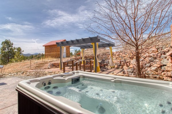 Escape to Mills Ranch, a breathtaking log cabin set on 10 private acres in Woodland Park. Enjoy spectacular views of Pikes Peak from your private hot tub or gather by the cozy wood burning fireplace. This spacious retreat features three bedrooms, a game room with a pool table, and a chef kitchen. Perfectly situated for outdoor adventures, this mountain getaway offers the ultimate Colorado experience for families and groups seeking comfort, privacy, and proximity to scenic hiking and regional attractions.