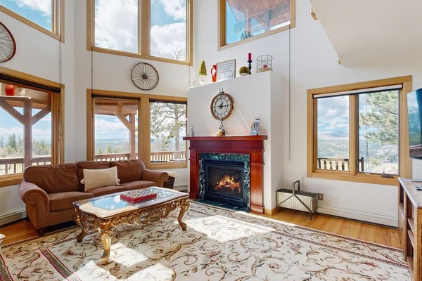 Escape to Skyline Ridge, a stunning 3-bedroom mountain retreat in Florissant. This secluded home features floor-to-ceiling windows with breathtaking views, a cozy fireplace, and a fully equipped kitchen. Enjoy outdoor living with a spacious yard and grill, or explore nearby Pikes Peak and Florissant Fossil Beds. With high-speed internet, a game room, and kid-friendly amenities, this peaceful oasis is the perfect basecamp for family adventures, gold mine tours, and scenic hikes just forty miles from Colorado Springs.