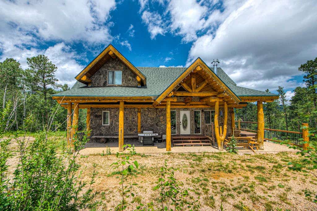 Discover your perfect Black Hills escape at this custom log and stone home in Deadwood. Set on ten private acres, this four bedroom retreat is ideal for families, offering a game room, spacious decks with stunning mountain views, and a fire pit for evening relaxation. With direct access to Forest Service land and proximity to Terry Peak, you can enjoy endless outdoor adventures and wildlife spotting. Experience the ideal combination of rustic charm, modern comfort, and natural beauty today.